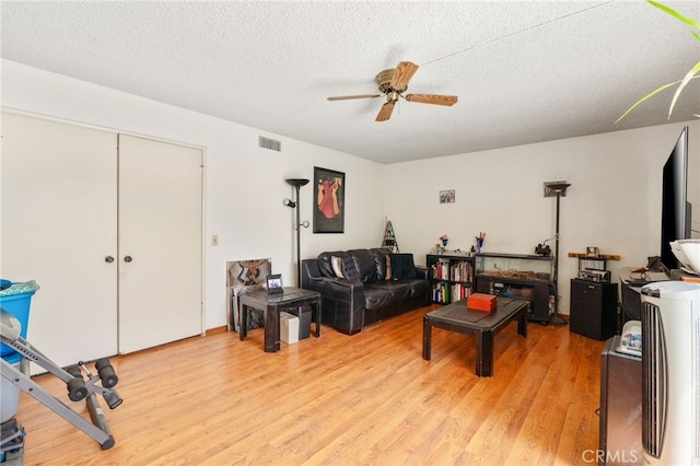 19722 Tajauta Ave, Carson, CA 90746 - living area with light wood finished floors, a ceiling fan, and a textured ceiling