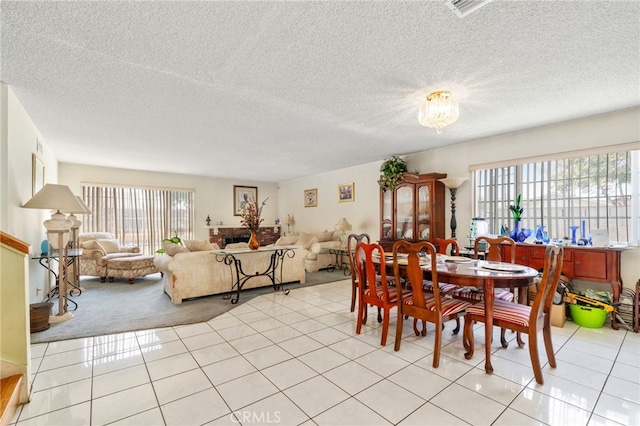 19722 Tajauta Ave, Carson, CA 90746 - dining space with healthy amount of natural light, light tile patterned floors, light carpet, and a textured ceiling