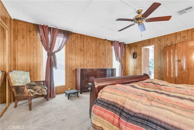 74084 Mercury Cir W, Palm Desert, CA 92260 - bedroom with multiple windows, wooden walls, light colored carpet, and a ceiling fan