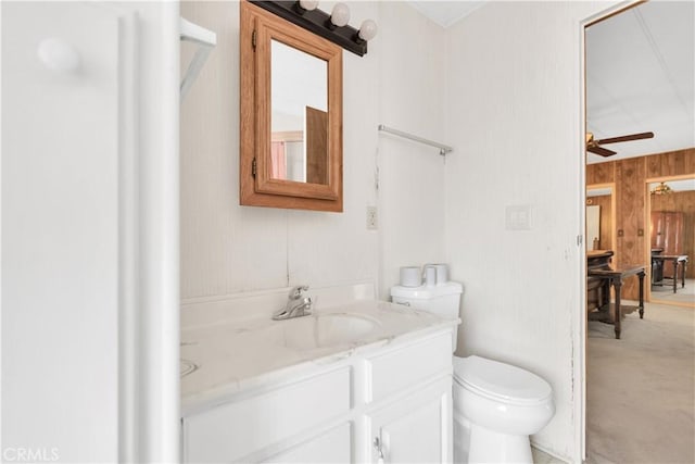 74084 Mercury Cir W, Palm Desert, CA 92260 - bathroom featuring vanity, ceiling fan, and wooden walls