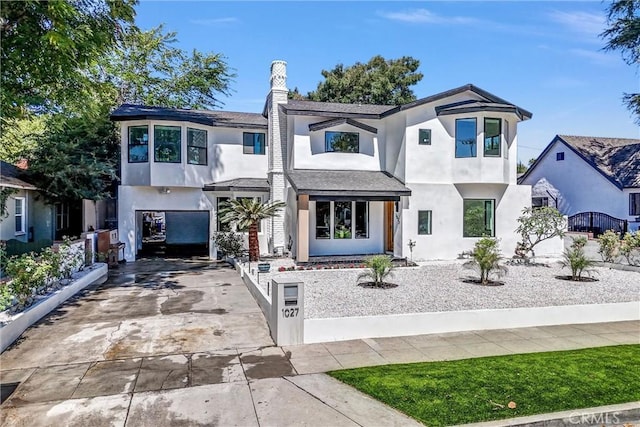 1027 N Lamer St, Burbank, CA 91506 - view of front facade with driveway, stucco siding, and a chimney