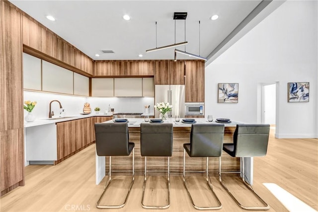 1027 N Lamer St, Burbank, CA 91506 - kitchen featuring appliances with stainless steel finishes, modern cabinets, light countertops, light wood-style floors, and recessed lighting