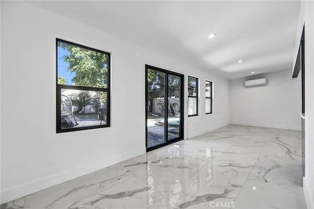 1027 N Lamer St, Burbank, CA 91506 - unfurnished room featuring marble finish floors, plenty of natural light, recessed lighting, and a wall mounted air conditioner