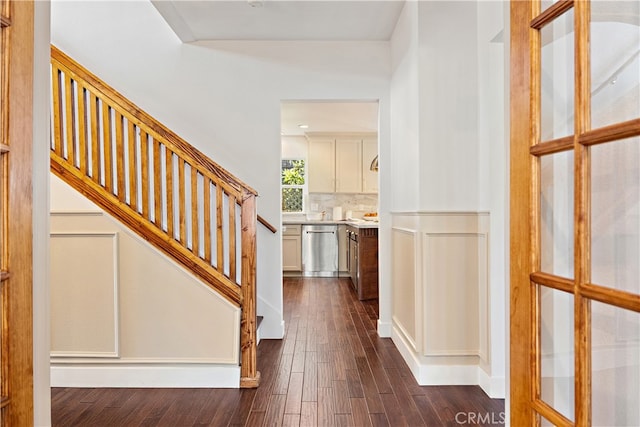 229 S Kingsley Dr, Los Angeles, CA 90004 - foyer entrance with dark wood finished floors, stairs, a decorative wall, and wainscoting