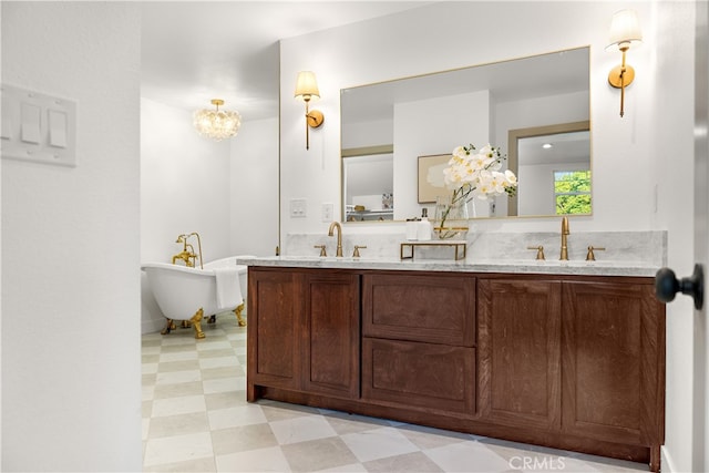 229 S Kingsley Dr, Los Angeles, CA 90004 - bathroom with tile patterned floors, double vanity, a soaking tub, and a chandelier