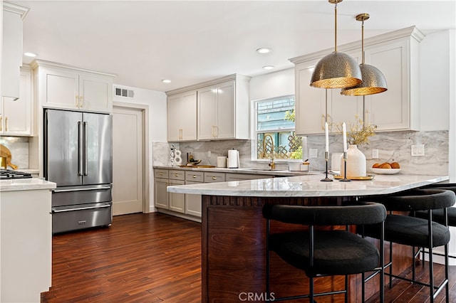 229 S Kingsley Dr, Los Angeles, CA 90004 - kitchen featuring high end fridge, a peninsula, dark wood-style flooring, tasteful backsplash, and light stone countertops