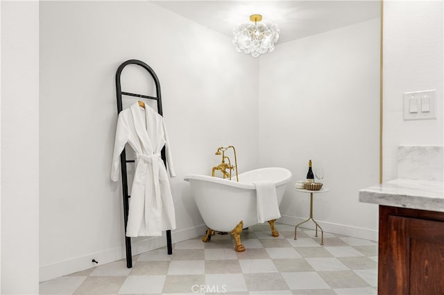 229 S Kingsley Dr, Los Angeles, CA 90004 - full bath featuring tile patterned floors, a chandelier, a freestanding bath, and vanity