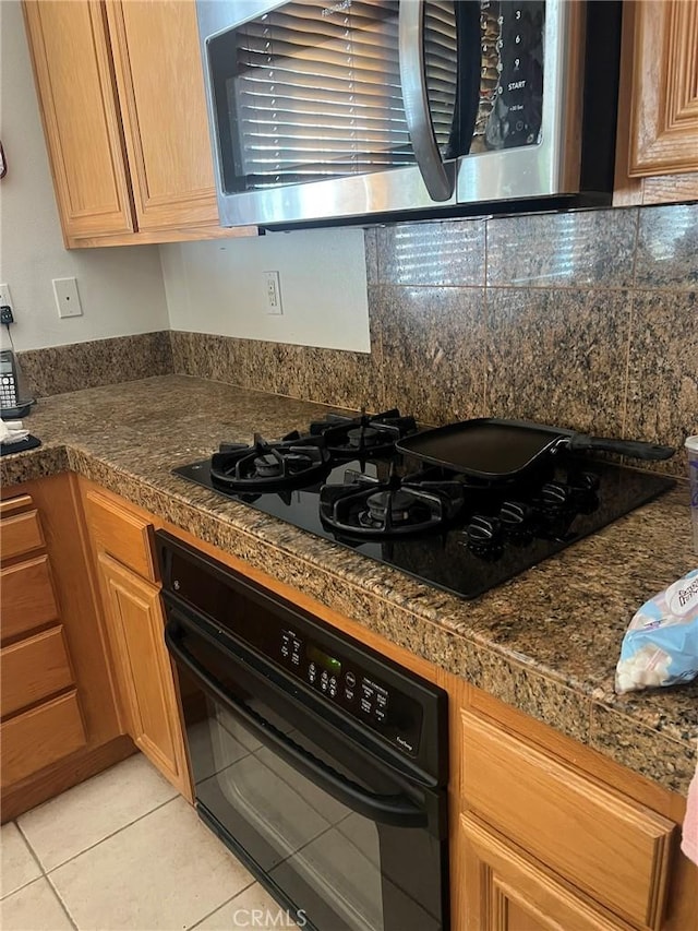 4630 Via Dulce, Camarillo, CA 93012 - kitchen featuring black appliances, tile counters, light tile patterned flooring, and decorative backsplash