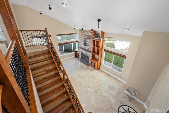 33551 Sandcastle Ct, Dana Point, CA 92629 - staircase featuring lofted ceiling, ceiling fan, plenty of natural light, a fireplace, and recessed lighting
