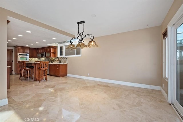 33551 Sandcastle Ct, Dana Point, CA 92629 - kitchen with open shelves, stainless steel appliances, a kitchen bar, a chandelier, and tasteful backsplash