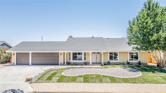 11617 Low Chaparral Dr, Victorville, CA 92392 - ranch-style house with a garage, driveway, roof with shingles, and stone siding