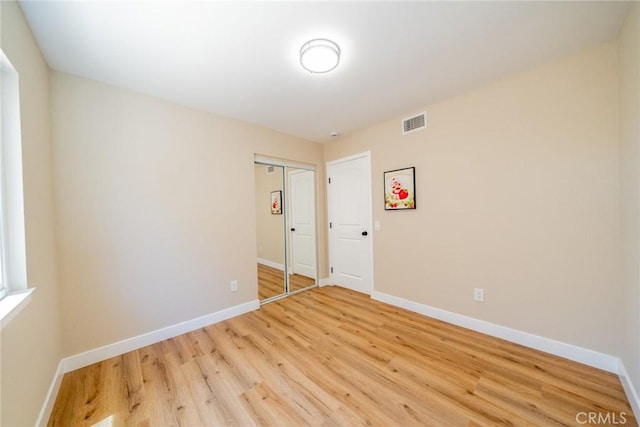 11617 Low Chaparral Dr, Victorville, CA 92392 - unfurnished bedroom featuring light wood-style floors and a closet