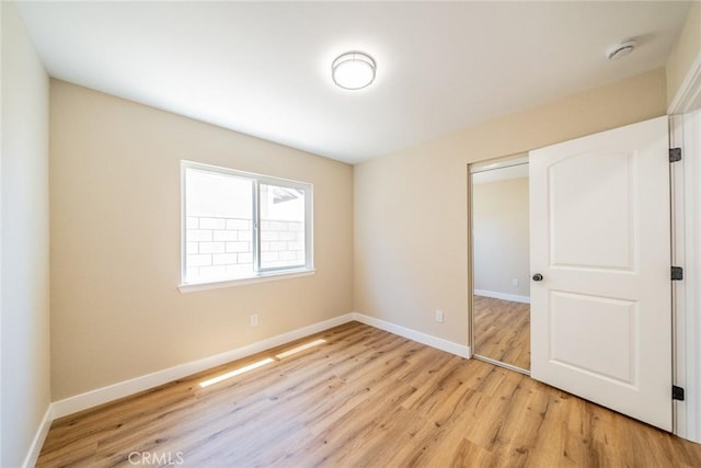 11617 Low Chaparral Dr, Victorville, CA 92392 - unfurnished bedroom featuring light wood-style flooring and a closet