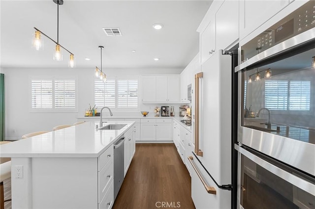 835 Orangedale Ave, Redlands, CA 92374 - kitchen with stainless steel appliances, dark wood-style floors, recessed lighting, light countertops, and white cabinets