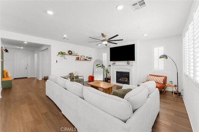835 Orangedale Ave, Redlands, CA 92374 - living area with a glass covered fireplace, wood finished floors, recessed lighting, plenty of natural light, and ceiling fan