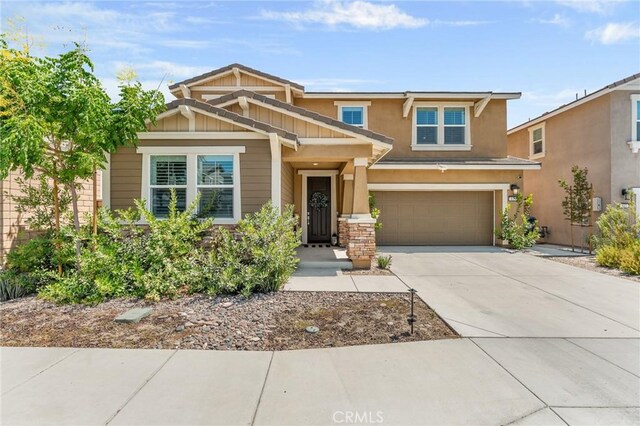 835 Orangedale Ave, Redlands, CA 92374 - craftsman-style home featuring an attached garage, concrete driveway, stucco siding, and board and batten siding