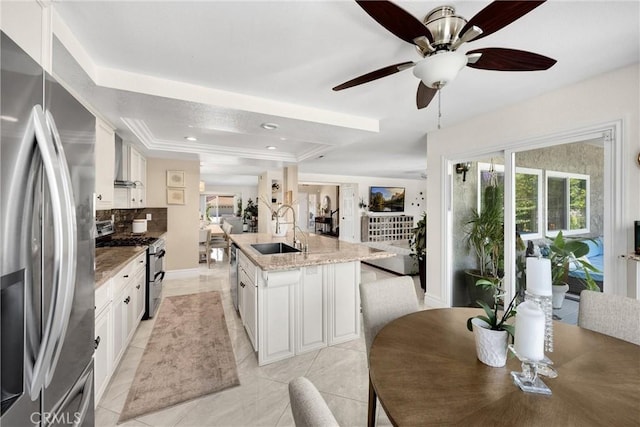 5999 Cedar Mountain Dr, Rancho Cucamonga, CA 91737 - kitchen with appliances with stainless steel finishes, a raised ceiling, backsplash, wall chimney exhaust hood, and ceiling fan