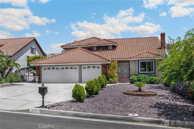 5999 Cedar Mountain Dr, Rancho Cucamonga, CA 91737 - mediterranean / spanish-style home with an attached garage, concrete driveway, a tiled roof, and stucco siding