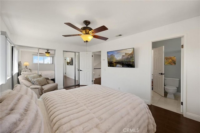 5999 Cedar Mountain Dr, Rancho Cucamonga, CA 91737 - bedroom featuring two closets, dark wood finished floors, a ceiling fan, and connected bathroom