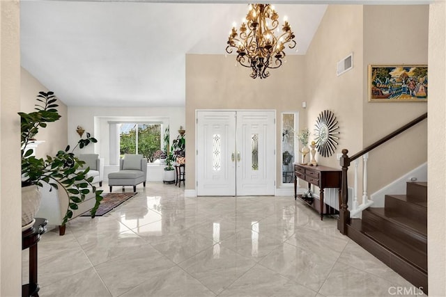 5999 Cedar Mountain Dr, Rancho Cucamonga, CA 91737 - entryway featuring light marble finish floors, a chandelier, high vaulted ceiling, and stairway