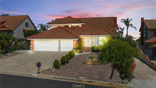 5999 Cedar Mountain Dr, Rancho Cucamonga, CA 91737 - mediterranean / spanish house featuring a tiled roof, concrete driveway, an attached garage, and stucco siding