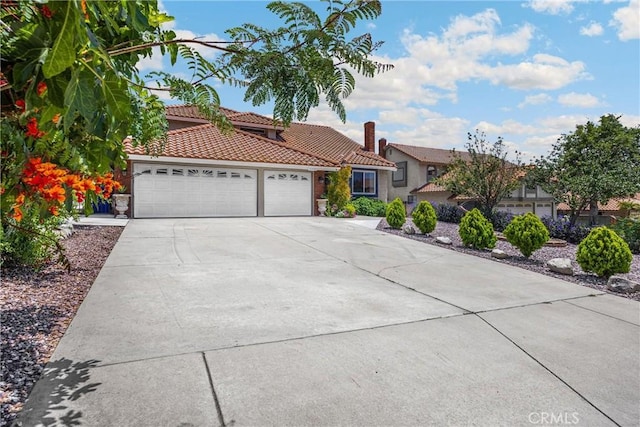 5999 Cedar Mountain Dr, Rancho Cucamonga, CA 91737 - mediterranean / spanish-style house with a garage, a tile roof, concrete driveway, and stucco siding