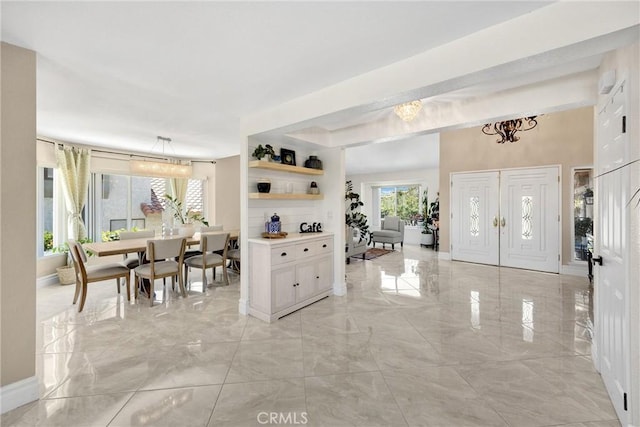 5999 Cedar Mountain Dr, Rancho Cucamonga, CA 91737 - foyer featuring light marble finish floors, plenty of natural light, and a chandelier