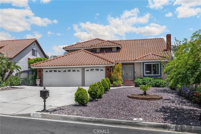 5999 Cedar Mountain Dr, Rancho Cucamonga, CA 91737 - mediterranean / spanish-style house with an attached garage, a tiled roof, driveway, and stucco siding
