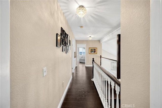 5999 Cedar Mountain Dr, Rancho Cucamonga, CA 91737 - hallway featuring an upstairs landing, a textured wall, dark wood-type flooring, and a chandelier