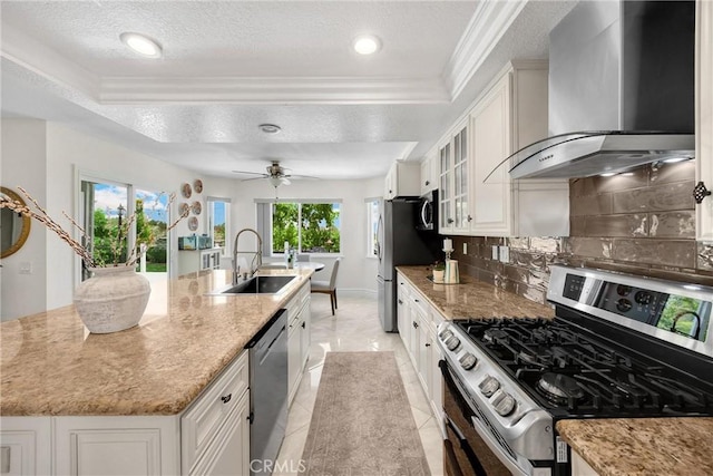 5999 Cedar Mountain Dr, Rancho Cucamonga, CA 91737 - kitchen with appliances with stainless steel finishes, wall chimney range hood, crown molding, a center island with sink, and decorative backsplash