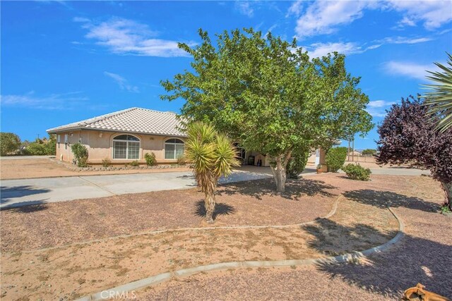 7330 Smoke Tree Rd, Phelan, CA 92371 - view of front facade with a tiled roof and stucco siding