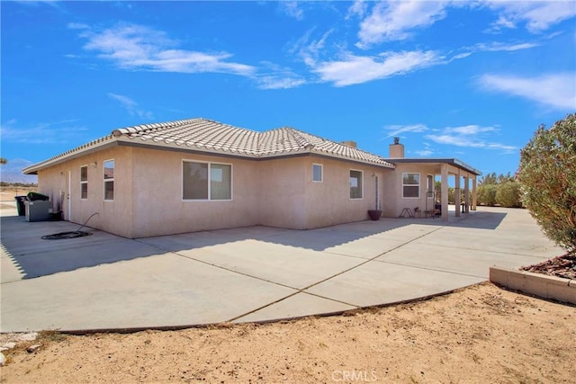 7330 Smoke Tree Rd, Phelan, CA 92371 - rear view of house with a patio, stucco siding, a tiled roof, and a chimney