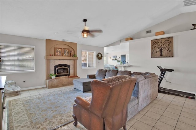 7330 Smoke Tree Rd, Phelan, CA 92371 - living area featuring light tile patterned flooring, lofted ceiling, ceiling fan, and a tiled fireplace