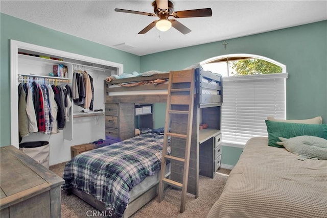 7330 Smoke Tree Rd, Phelan, CA 92371 - bedroom with carpet, a closet, a ceiling fan, and a textured ceiling
