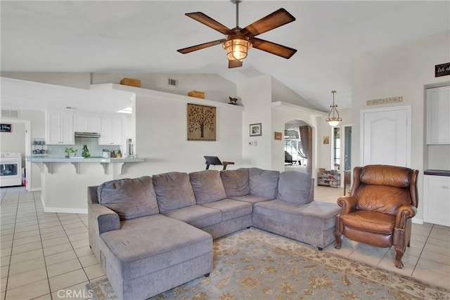 7330 Smoke Tree Rd, Phelan, CA 92371 - living area with lofted ceiling, light tile patterned floors, ceiling fan, arched walkways, and washer / dryer