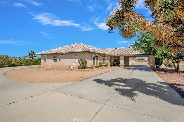 7330 Smoke Tree Rd, Phelan, CA 92371 - mediterranean / spanish-style home featuring driveway, stucco siding, and a tiled roof