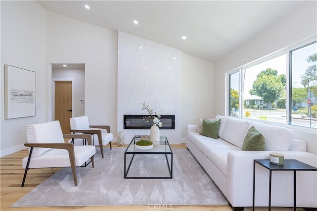 17905 Bullock St, Encino, CA 91316 - living area with light wood finished floors, recessed lighting, a fireplace, and high vaulted ceiling