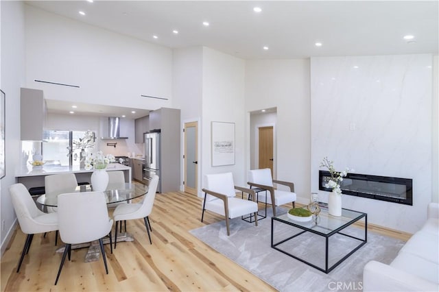 17905 Bullock St, Encino, CA 91316 - living area with a towering ceiling, a fireplace, recessed lighting, and light wood-type flooring