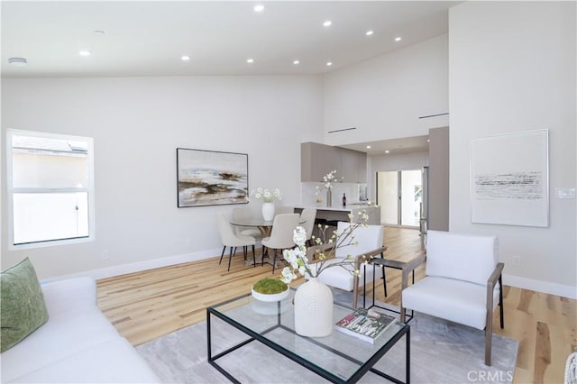 17905 Bullock St, Encino, CA 91316 - living area featuring light wood-type flooring, healthy amount of natural light, recessed lighting, and a high ceiling