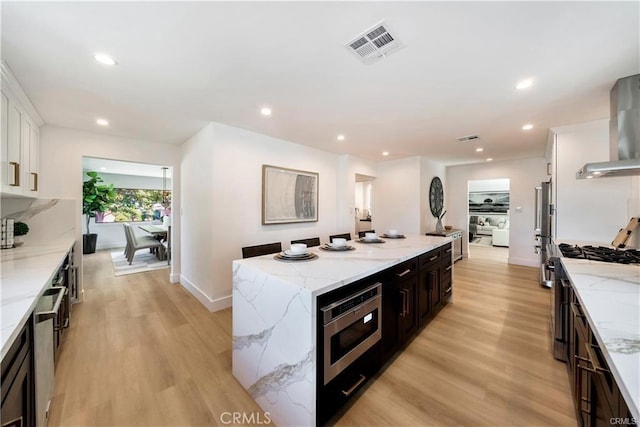 1603 Sunnyside, San Pedro, CA 90732 - kitchen with stainless steel appliances, a center island, light wood finished floors, white cabinets, and recessed lighting