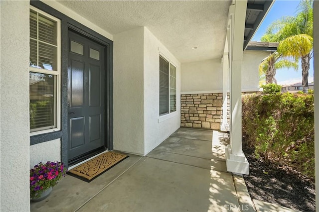 36845 Gemina Ave, Murrieta, CA 92563 - doorway to property with stucco siding, covered porch, and stone siding