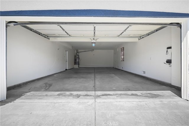 36845 Gemina Ave, Murrieta, CA 92563 - garage with a garage door opener and baseboards