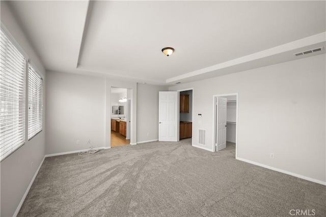 36845 Gemina Ave, Murrieta, CA 92563 - unfurnished bedroom featuring light colored carpet, a spacious closet, and ensuite bathroom