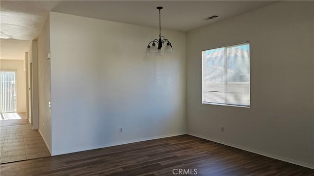 9019 Fremont Ct, Oak Hills, CA 92344 - unfurnished dining area with a chandelier and dark wood-style floors