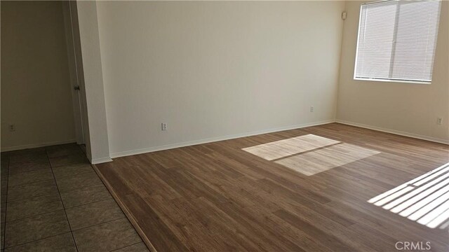 9019 Fremont Ct, Oak Hills, CA 92344 - unfurnished room featuring dark wood-style flooring and baseboards