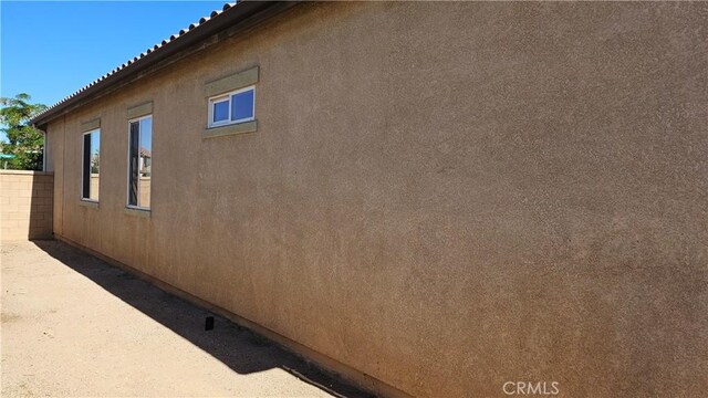 9019 Fremont Ct, Oak Hills, CA 92344 - view of side of property featuring stucco siding