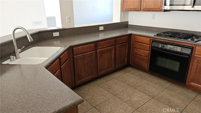 9019 Fremont Ct, Oak Hills, CA 92344 - kitchen featuring appliances with stainless steel finishes, dark countertops, and light tile patterned floors