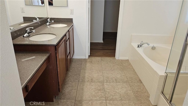 9019 Fremont Ct, Oak Hills, CA 92344 - full bath with double vanity, a garden tub, tile patterned flooring, and a shower with door