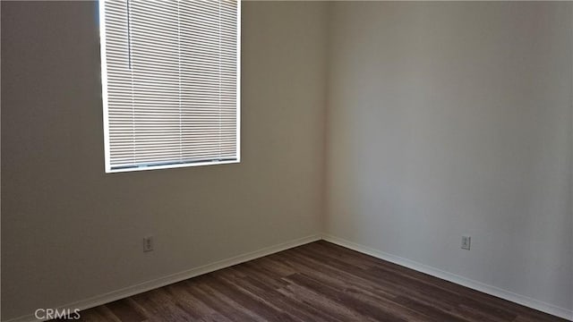 9019 Fremont Ct, Oak Hills, CA 92344 - unfurnished room with dark wood-type flooring and baseboards