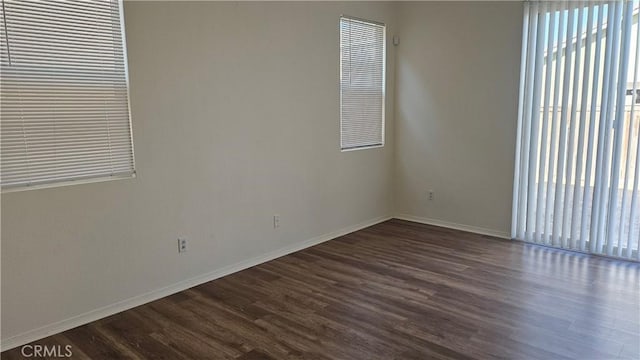 9019 Fremont Ct, Oak Hills, CA 92344 - spare room with dark wood-style floors and baseboards